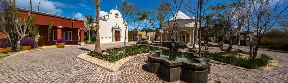 Colonial-style plaza at Mayakoba with chapel, fountain, and event spaces
