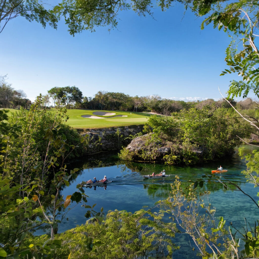Kayaking through a natural cenote with golf course views at The Reserve at Mayakoba