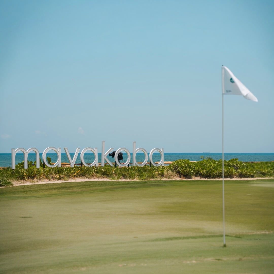 Controlled access point at The Reserve at Mayakoba, featuring the iconic Mayakoba sign by the sea
